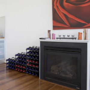 Vinrac wine racks next to a fireplace.
