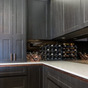 Vinrac wine racks on top of a kitchen bench against a mirror.